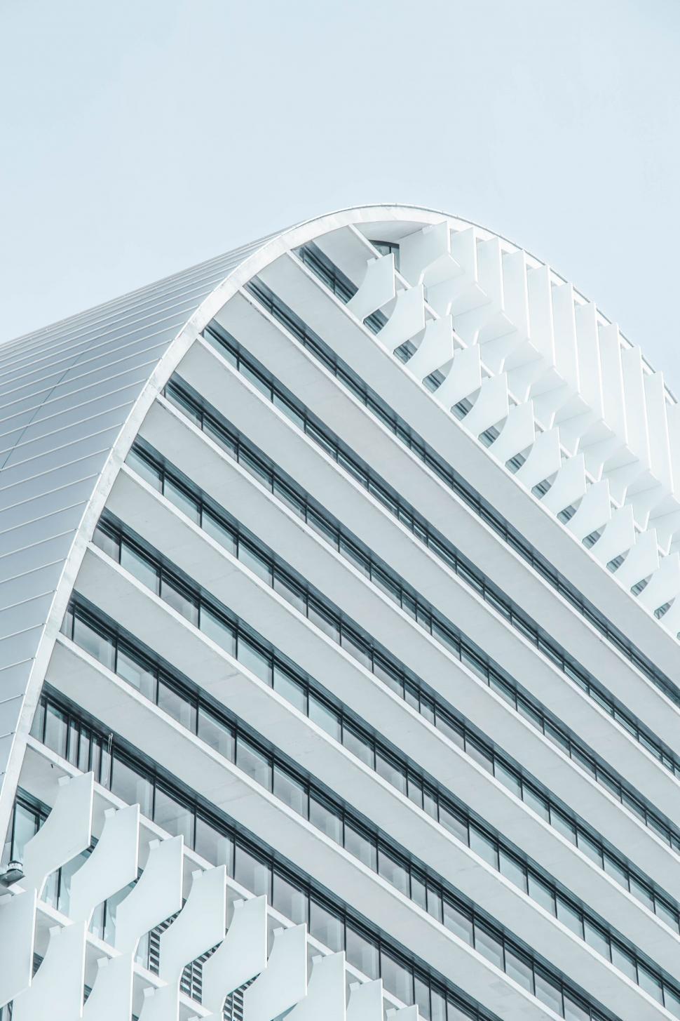 Free Image of Tall White Building Against Sky Background 