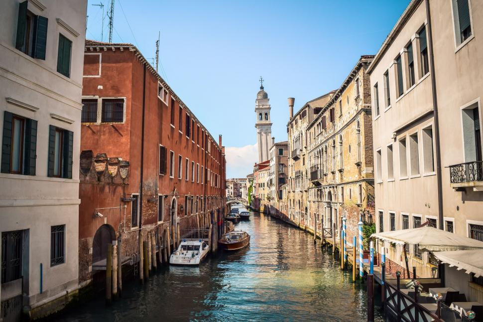 Free Image of Clock Tower Overlooking Narrow Canal in City 