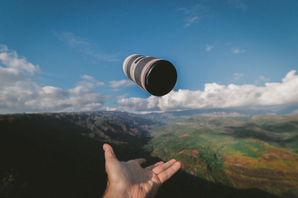 Free Image of Hand Holding Black and White Striped Object 