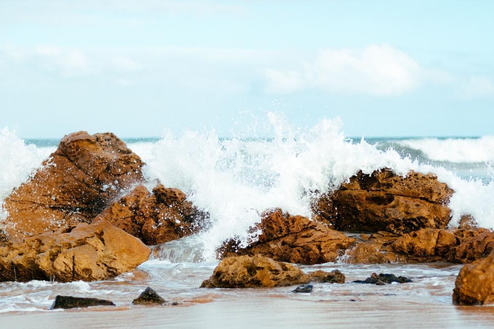 Free Image of Person Standing on Beach With Surfboard 