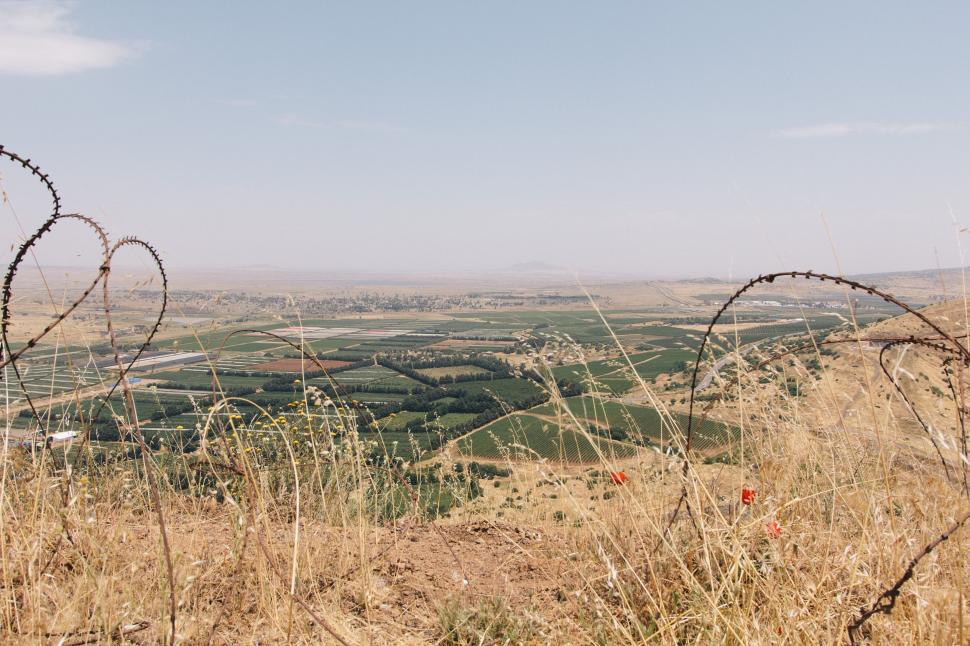 Free Image of A View of a Field With a Barbed Wire Fence 