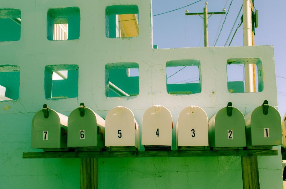 Free Image of Row of White Urinals on Green Wall 